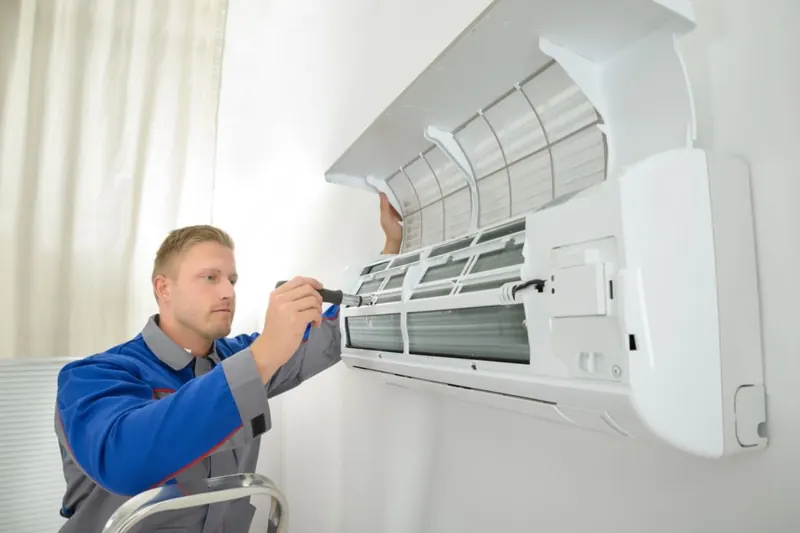 Technician opening an indoor split unit to find a fault