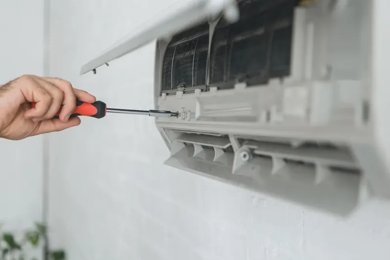 Screwdriver on the opened casing of an indoor split unit
