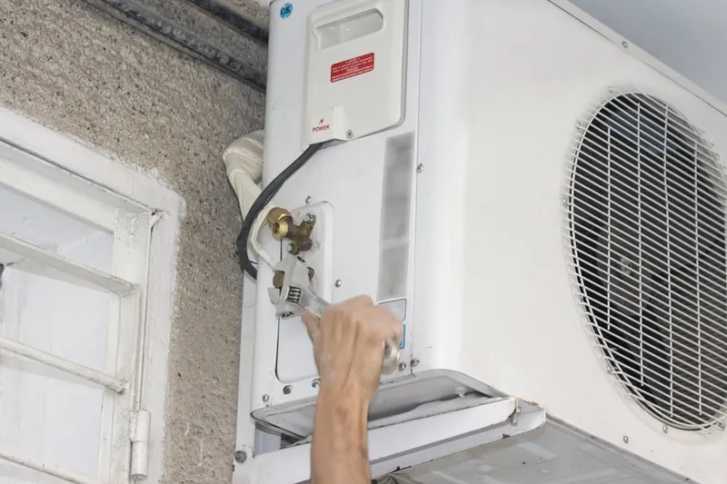 Spanner on the service valves of an outdoor aircon unit