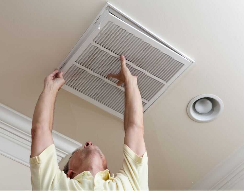 Picture of technician installing a central air conditioning unit